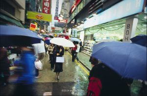people on the street in Hong Kong during a rain storm