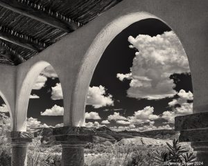 Cumulus clouds framed by arches.