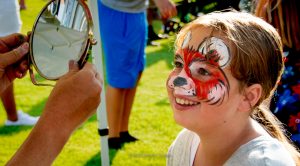 smiling little girl with a painted face