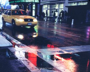 taxi on wet streets in NYC