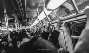 hands hangin on in the NYC subway